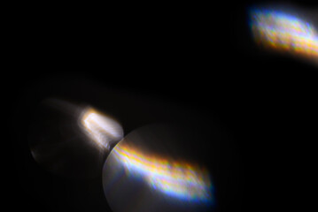 Iridescent light leaks on black background for overlay use. Optical prism flare creating rainbow glow effect for creative photo manipulation