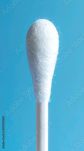 Macro Shot of a White Cotton Swab Tip Over a Blue Background