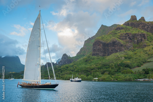 Tableau sur toile Classic Sailing Superyacht with mainsail hoisted leaving Cook's Bay, in the paci