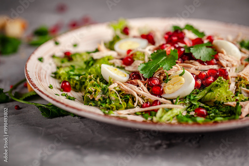 Fresh chicken salad with pomegranate and egg