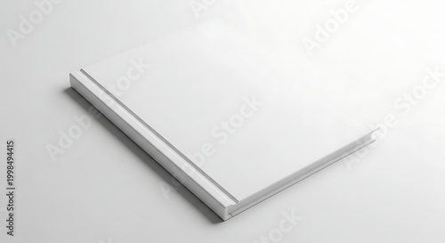 A clean, minimalist, high-angle shot of a blank white hardcover book lying flat on a white surface, casting a soft shadow.