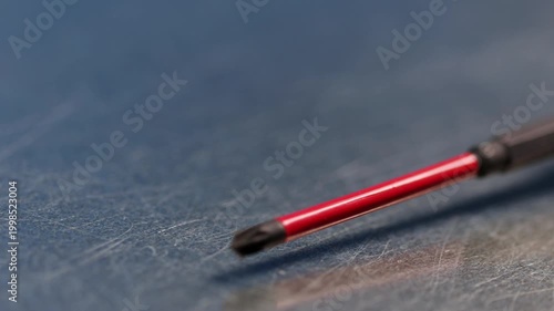 Screwdriver with an insulated handle for installing equipment. Soft focus. Close-up. Macro. 