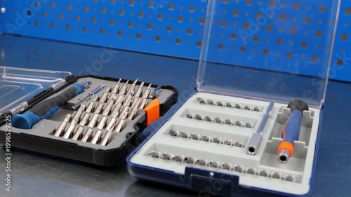 A set of metal bits for installation work in a plastic case.