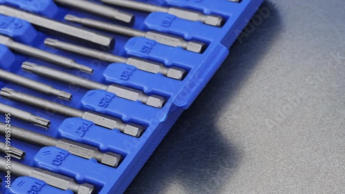 A set of metal bits for installation work in a plastic case.