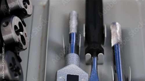 A set of tools for threading in a metal case.