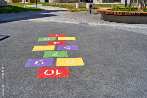 Konstfotografi A colorful hopscotch game painted on an asphalt surface in an outdoor playground or park area