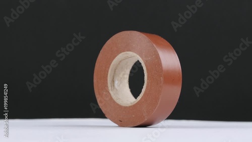 The insulation tape in a roll rotates around its axis. 