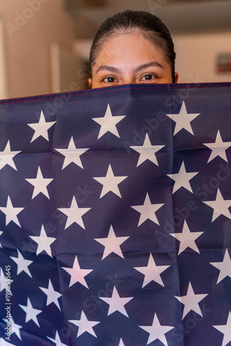 Latin American woman holding a USA flag, showing patriotism and national pride