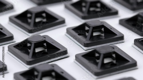 Plastic self-adhesive pad for installing nylon ties.