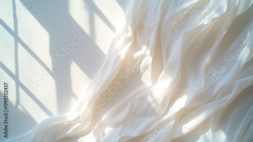 Soft drapery fabric illuminated by natural light with window shadow pattern