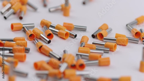 Metal tips with a plastic base for mounting on stranded copper wires. Close-up. Soft focus. Macro.