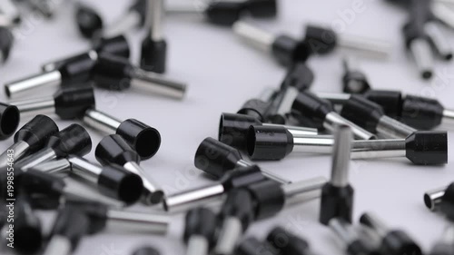 Metal tips with a plastic base for mounting on stranded copper wires. Close-up. Soft focus. Macro.