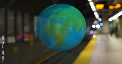 Hovering 3D globe showing Africa and Europe floating above subway platform, with yellow strip
