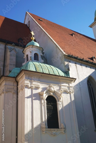 St Martins Cathedral in Bratislava Slovakia with Detail of Baroque Chapel featuring Green Copper Dome and Red Tiled Roof on Historic European Landmark Background under Clear Blue Sky.