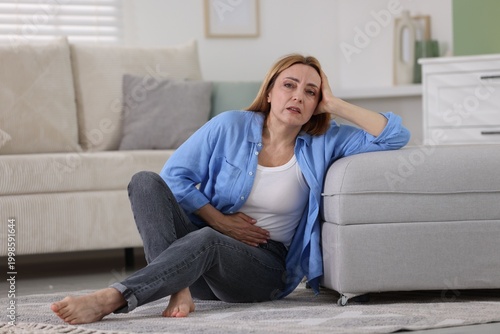 Konstfotografi Menopause. Woman suffering from abdominal pain at home