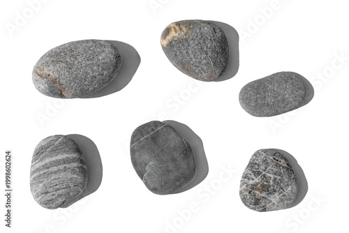 Overhead arrangement of six organic grey rocks isolated on white or transparent background. Authentic textured pebbles with unique mineral patterns for eco-friendly branding and zen visuals