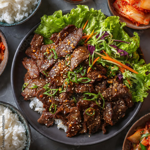 A steaming plate of Korean bulgogi, thinly sliced marinated beef glistening with caramelized sauce, garnished with sesame seeds and scallions, served on a bed of crisp lettuce leaves with a side of ki