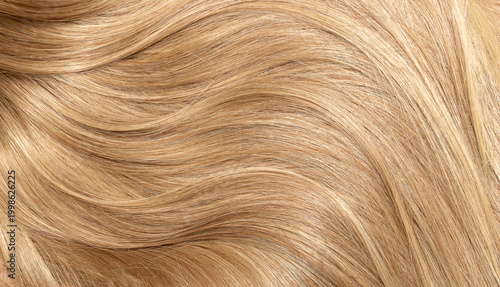 Blond hair close-up as a background. Women's long blonde hair. Beautifully styled wavy shiny curls. Hair coloring. Hairdressing procedures, extension.