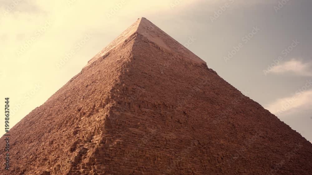 Smooth horizontal camera lift revealing full central pyramid of Giza ...