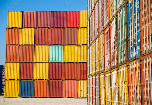 Stacked shipping containers in a warehouse yard