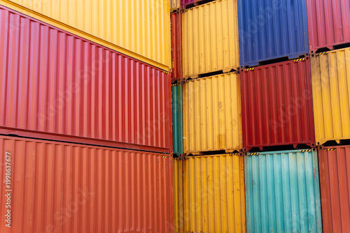 Stacked shipping containers in a warehouse yard