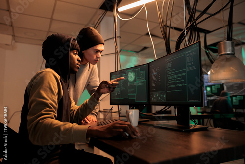 Fotografie Diverse hackers planning data breach with virus, analyzing firewall encryption to hack computer system