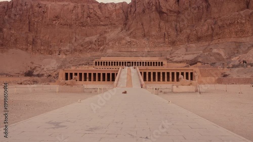 Smooth tracking shot of tourists approaching Hatshepsut Temple, Luxor. Cinematic forward movement along the main path leading to the Hatshepsut Temple in Luxor