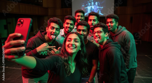 Indian young adult gen z male man female look camera take selfie photos have fun joy hall stage place. Happy teen girl boy group team staring cam do funny pose record video spend day enjoy break time