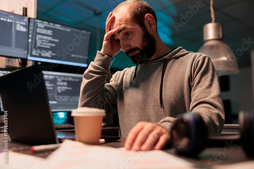 Konstfotografi Stressed overworked developer programming html code on laptop and multiple monitors, working under stress after hours