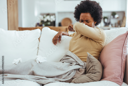 Canvastavla Sick Woman Coughing on Couch Under Blanket With Tissues While Resting at Home