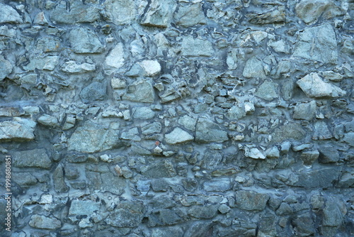Rustic Grey Stone Wall Texture with Irregular Natural Rocks and Cool Blue Tones, Rugged Rubble Masonry Background for Architecture, Medieval Fortress Wall Surface, Organic Hard Rock Pattern Detail