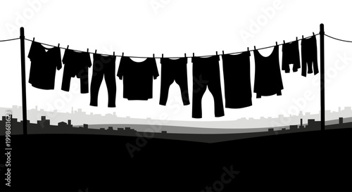 Laundry hangs from clothesline on a hazy city skyline