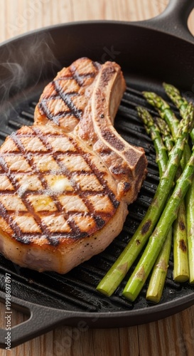 Grilled Pork Chop with Asparagus on Cast Iron Skillet.