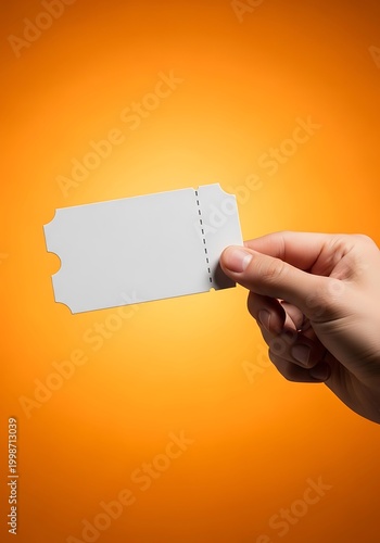 Hand holding a blank white ticket against an orange background