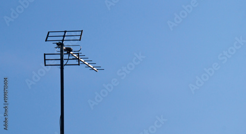 Tableau sur toile TV antenna on blue sky background