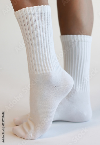 Female Legs Wearing White Ribbed Crew Socks Side View Minimal Studio Shot