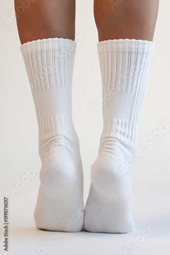 Woman Legs in White Cotton Crew Socks Standing Back View