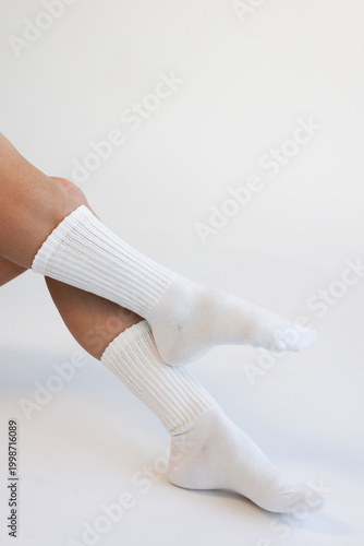 White Ribbed Crew Socks on Female Legs on White Background