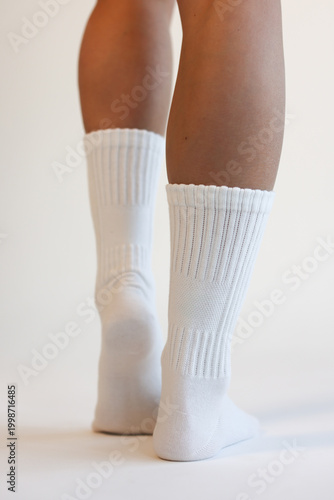 Woman Legs in White Cotton Crew Socks Standing Back View