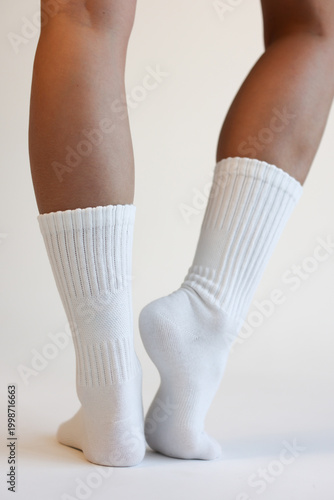 Woman Legs in White Cotton Crew Socks Standing Back View