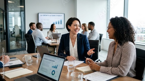 Diverse business team collaborating in modern office conference room with growth charts and analytics data displayed. Corporate teamwork, professional communication, data-driven strategy.