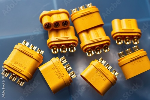 Obraz na płótnie Close-up of yellow MR60 3-phase power connectors, featuring shiny gold-plated brass terminals