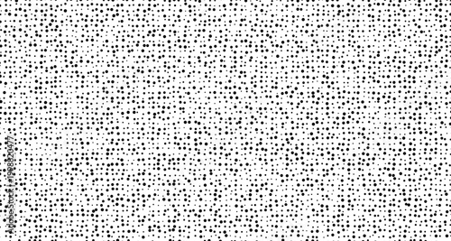 Black dots scattered on a white background pattern