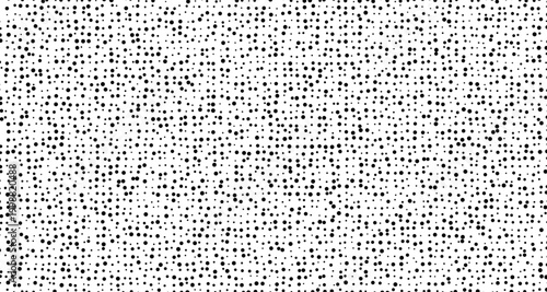 Black dots scattered on a white background pattern