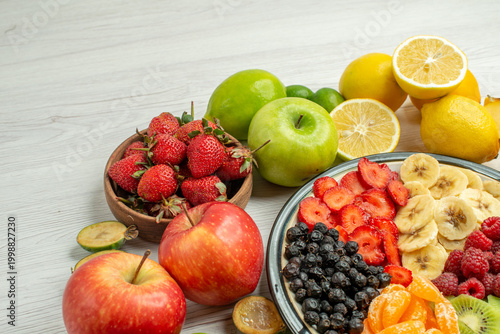 front view fruit composition with sliced fruit salad on white background exotic fruity berry ripe mellow photo