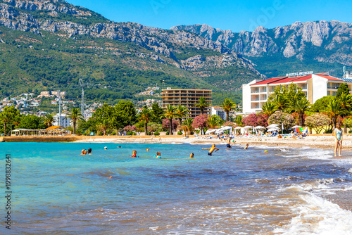 Bar Montenegro Beach tourists people water waves sun loungers parasols.