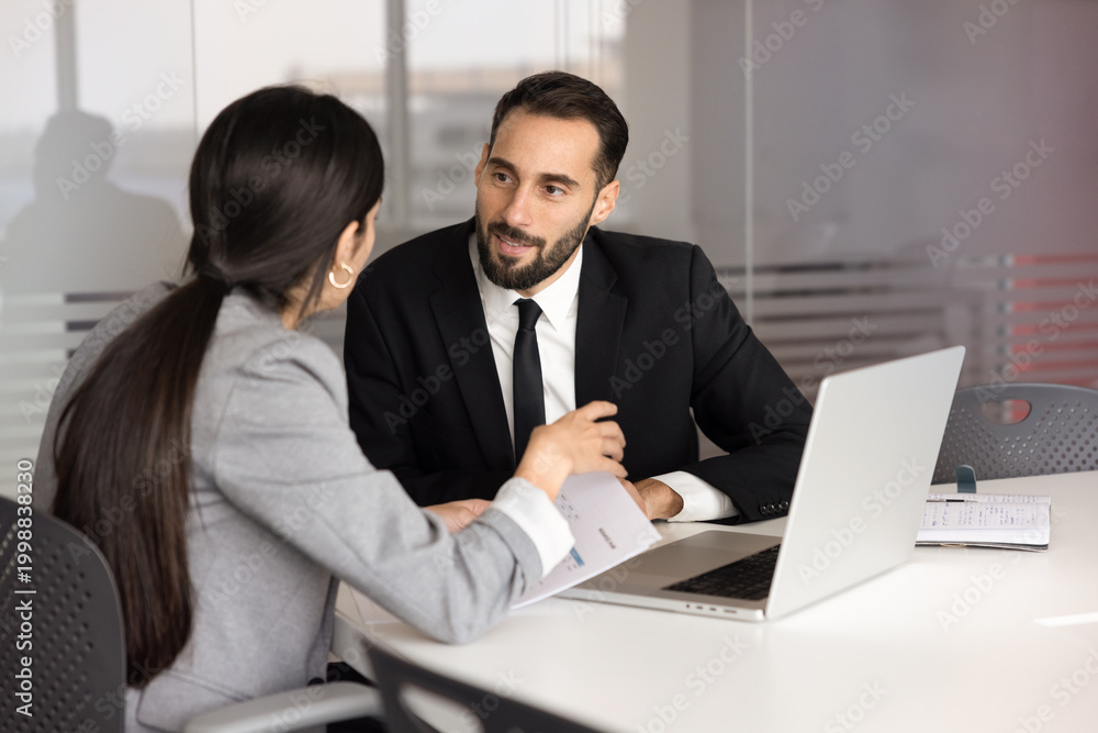 Fototapeta premium Team members working on business task during teamwork in office boardroom, share ideas, planning strategic decision, discussing report result, explain solution, speaking, sitting at table with laptop