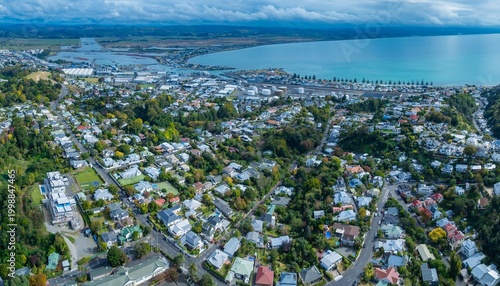 Aerial view of Napier City, Hawke's Bay, New Zealand. Residential homes and industrial buildings are seen along the coast. The city is a popular tourist destination.