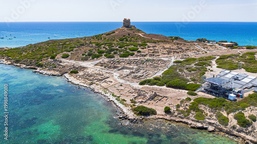 Aerial view of the ancient archaeological site of Tharros with Roman columns and ruins overlooking the sea, Sinis peninsula, Sardinia, Italy