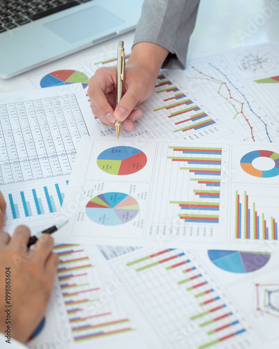 Businesspeople evaluate project efficiency and financial figures with business team for marketing research and business strategy plan.